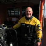 Richard Smart, NWK Club Secretary, in drysuit on a dive boat