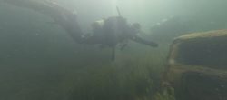 Diver navigating between sunken objects at Leybourne Lakes